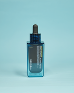 Imazh i ampulës së fytyrës MEDIHEAL Madecassoside Derma Ampoule Blemish Repair (50ml). Ampula qetëson skuqjet/irritimet dhe lufton njollat e akneve me 92% Ekstrakt Tea Tree dhe përbërësit rigjenerues Madecassoside dhe Centella Asiatica.