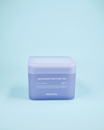 mazh i tamponëve të pambukut/pads hidratuese MEDIHEAL Watermide Moisture Pad (100 copë). Pads-at ofrojnë hidratim të thellë dhe freski të menjëhershme, rigjenerojnë barrierën me kompleksin inovativ WaterActive™ dhe ujin akullnajor islandez.